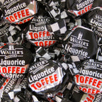 Individual pieces of Walkers Liquorice Toffee in distinctive black foil wrappers.